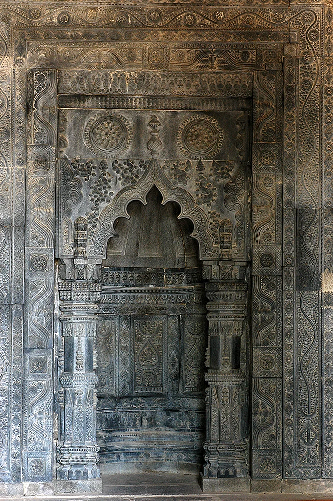 Mihrab carved with motifs of water-vessels, flora, roses, and grape clusters